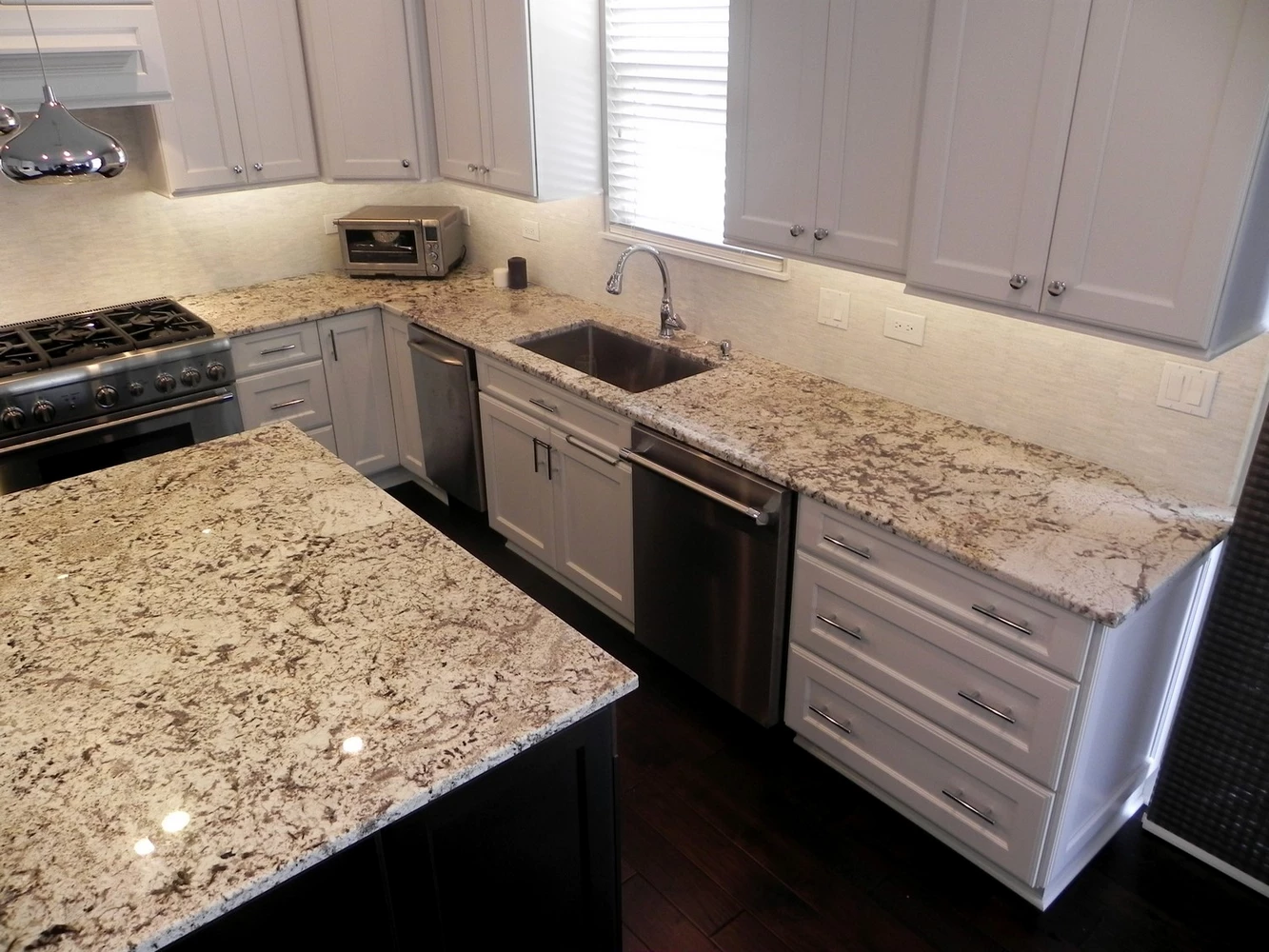 Modern white kitchen renovation with elegant marble backsplash