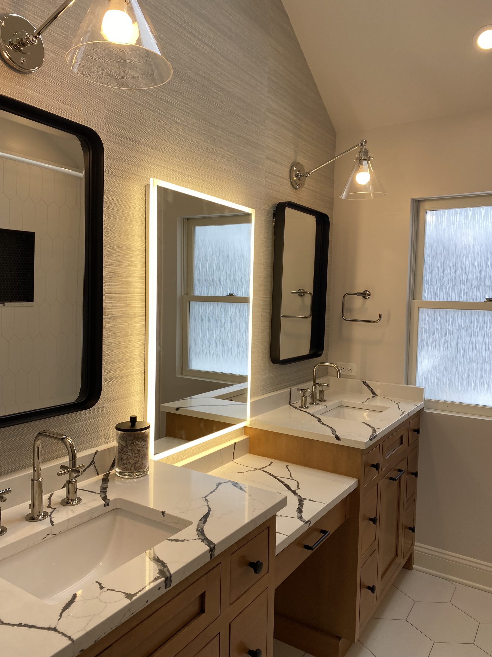 Contemporary bathroom remodel highlighting vanity cabinets and mirror