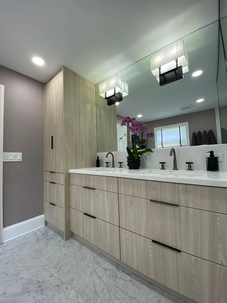 Bathroom renovation with white countertop and matte black faucet