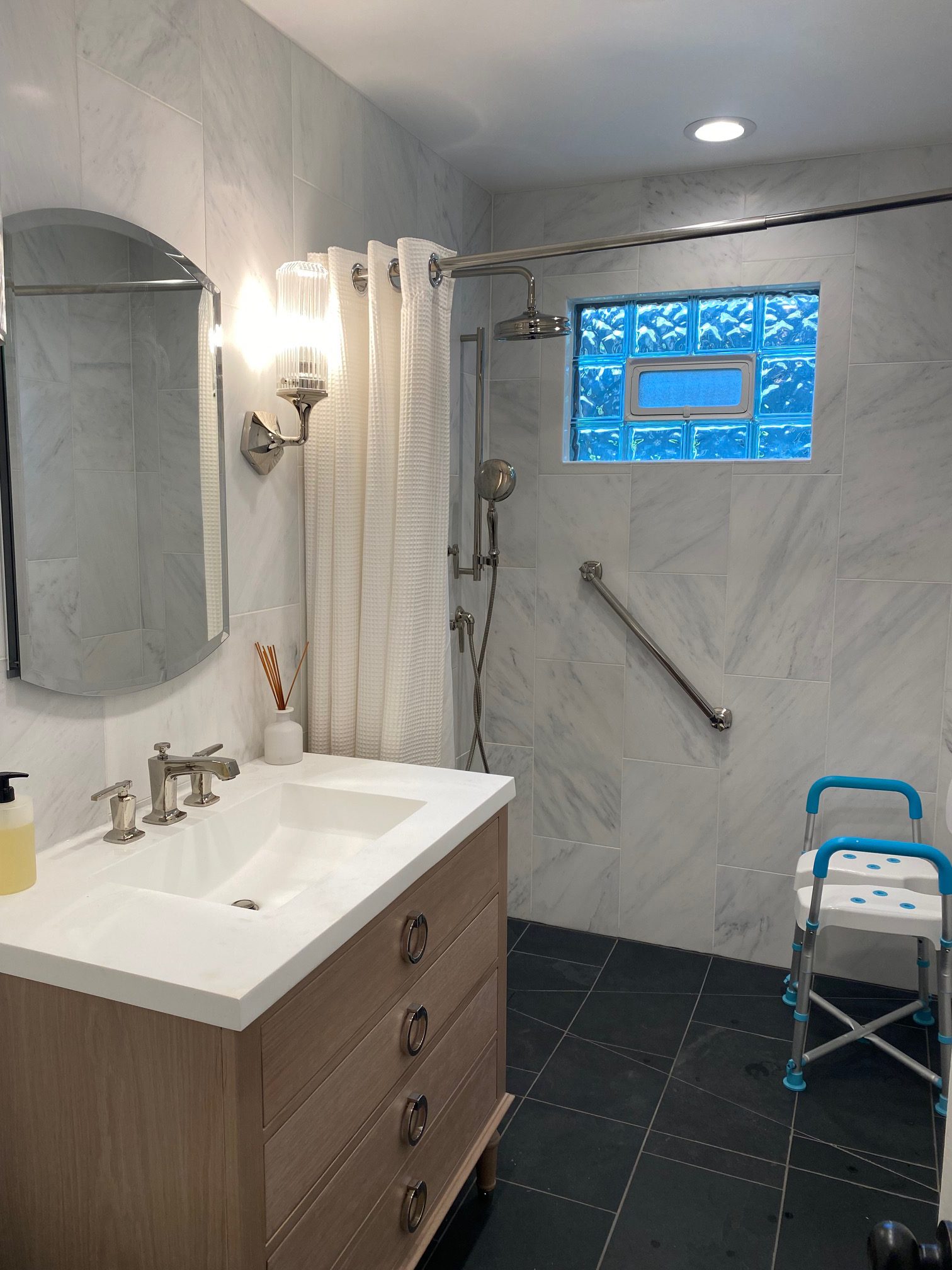 Renovated bathroom featuring contemporary countertop and fixtures