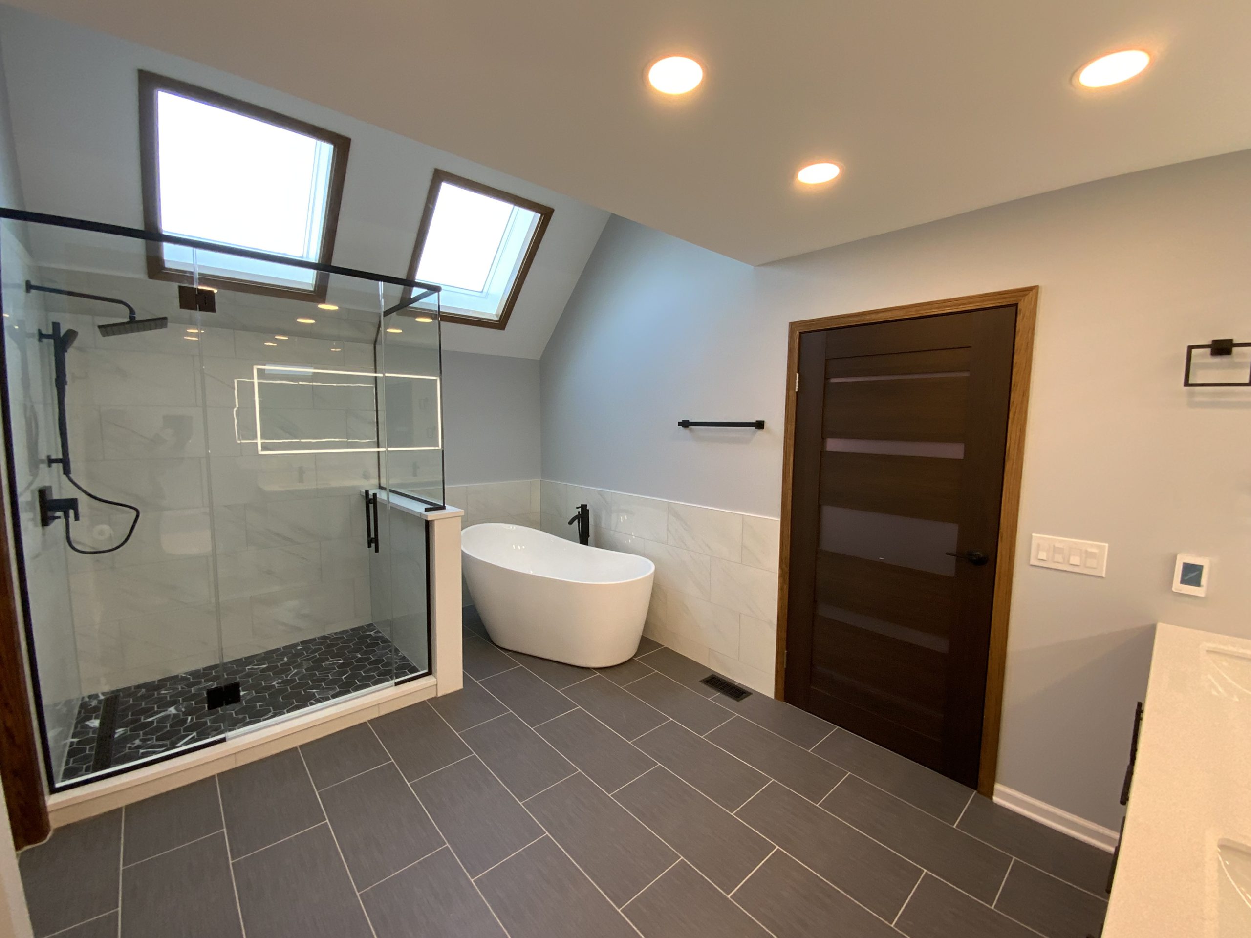 Luxury bathroom remodel featuring freestanding bathtub and vanity